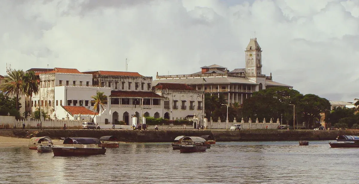 The Stone Town waterfront in Zanzibar with the old buildings and wooden boats, the start of Serengeti safari packages with Zanzibar flights